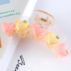 Matte pink and yellow heart hair claw clip in transparent plastic for women's updos