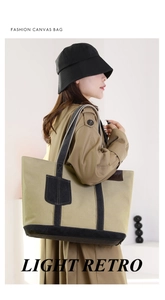 Detail der khakifarbenen Segeltuchtasche mit schwarzen Lederriemen und Retro-Design