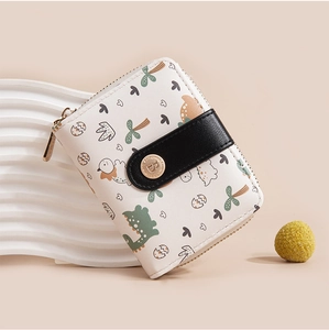 Close-up of cream PU leather wallet featuring cute cartoon dinosaur prints and gold snap button