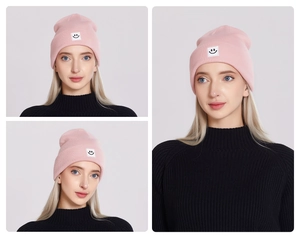 Three-angle views showing the pink beanie with a minimalist black smiley face patch