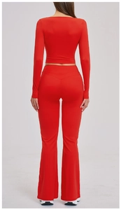 Back view of red long sleeve cropped top and high-waisted flared yoga pants set
