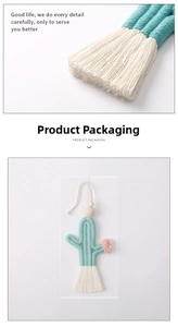 Macro detail of handmade cactus cotton rope keychain with mint green fringe and bead