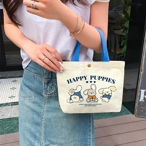 Mini cream canvas tote bag with blue handles and happy puppies cartoon print