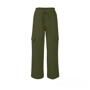 Detailed view of elastic drawstring waist and side cargo pockets on green linen pants