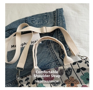 Detail of adjustable woven shoulder strap and silver metal hooks on the floral canvas bag