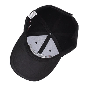 Detail view of baseball cap interior showing 100% acrylic material tag and stitching