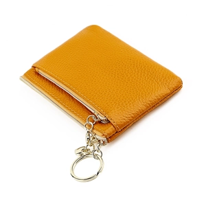 Close-up of yellow genuine leather coin purse with gold zipper and keychain detail