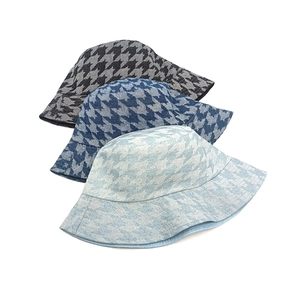 Three stylish houndstooth check bucket hats in black, navy, and light blue denim