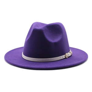Detail of dark purple wool fedora hat featuring a beige leather band and gold metal buckle