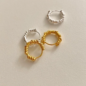 Detailed view of spiral texture hoop earrings in gold and silver finish minimalist style