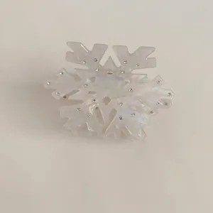 Macro shot of acetic acid snowflake hair claw with sparkling crystals and pearl luster