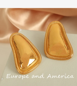 Detail showing 18K gold geometric earrings with mirror polish and textured edges
