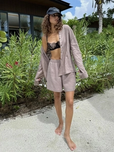 Detail of linen-cotton fabric texture on dusty pink long sleeve shirt and shorts set