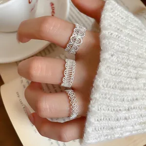 Elegant silver lace hollow flower rings set for women worn in a cozy lifestyle setting