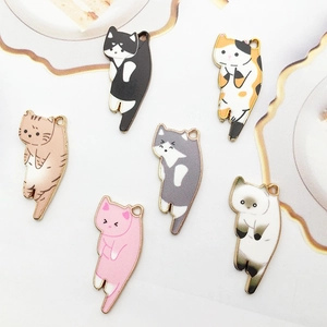 Selection of six colorful cat enamel charms with distinct patterns on a white base