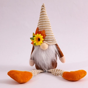 Detail of fall gnome plush featuring striped pointed hat with sunflower and maple leaf decoration