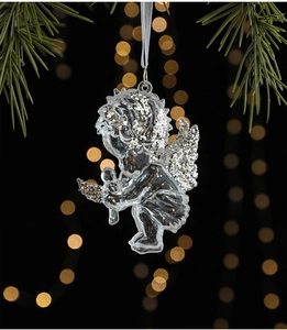 Clear acrylic Christmas angel ornament with silver glitter detail and warm bokeh background