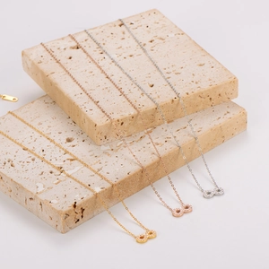 Three minimalist infinity symbol necklaces in gold, rose gold, and silver stainless steel