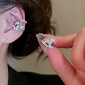 Elegant rocking horse ear cuff with white zircon stones on a silver metal base