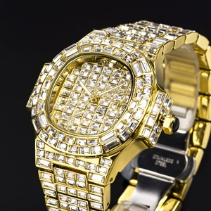 Detailed macro view of gold-tone luxury watch showing date display and diamond-encrusted bezel
