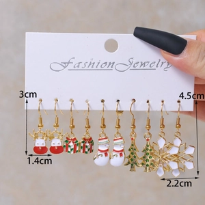 Christmas earrings set with reindeer, snowman and tree designs on display card