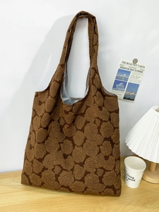 Close-up of brown rose embossed textured tote bag with high-quality knit finish