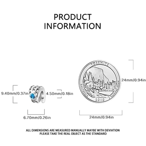 Detailed dimensions of silver cross charm with blue gemstone next to reference coin