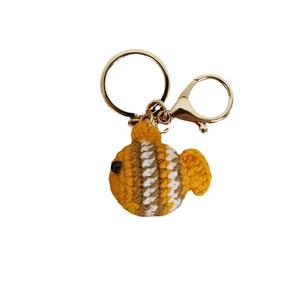 Handmade crochet clownfish keychain in yellow with stripes and golden metal ring