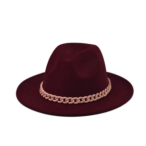 Detail shot of a maroon wool fedora hat featuring a chunky matte pink chain decorative band