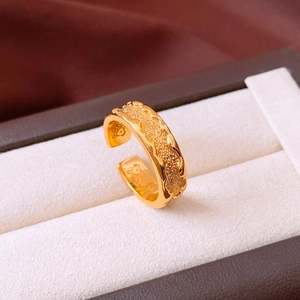 Detailed macro view of 24k gold plated ring featuring inner fish engraving and wave edges