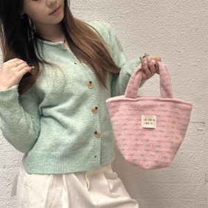 Detail of pink plush tote bag with colorful specks and sozakka beauté label on front