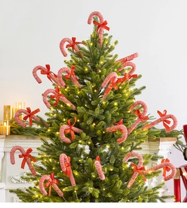 Close-up of red and white striped Christmas candy cane ornaments with festive bows