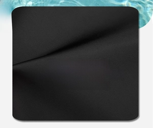 Close-up of waterproof high-density black nylon fabric showing fine texture and durability