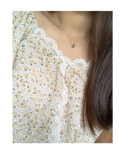 Close-up of minimalist S925 silver necklace with a green jade pendant on a model