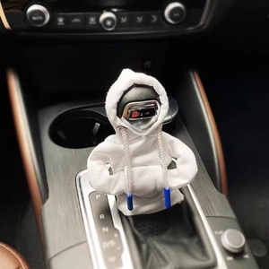 Detail of white hoodie-style car gear shifter cover with blue drawstring in vehicle