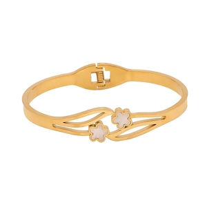 Golden wave bangle with white floral accents on a minimalist polished stainless steel band