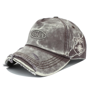 Detailed embroidery on vintage washed grey denim baseball cap with distressed ripping