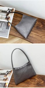 Detail of grey woven texture on women's PU leather shoulder bag with glossy finish