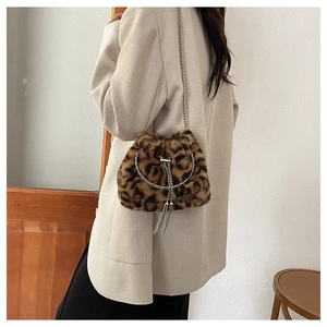 Detail of leopard print faux fur bucket bag with silver chain strap and tassel