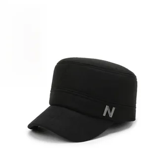 Close-up of black wool texture and metallic N detail on a winter cadet cap
