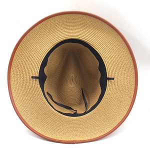 Detail view of woven straw fedora interior showing black sweatband and adjustable straps