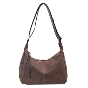 Close-up of brown suede hobo bag featuring adjustable strap and tassel detail