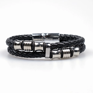 Macro detail of black braided leather bracelet with silver magnetic metal clasp
