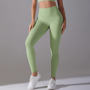 Detail view of high-waist light green yoga leggings showing the seamless slimming waistband