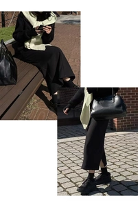 Outdoor shot of a flowing black mid-length skirt with a soft texture on a brick walkway