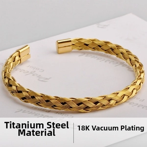 Detail view of woven titanium steel cuff bracelet with vacuum plated 18K gold finish