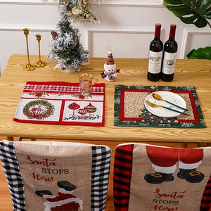 Christmas placemats and Santa chair covers with buffalo plaid on a wooden festive table