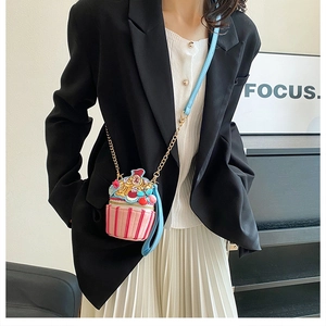Crossbody cupcake shaped mini bag with pastel colors and metal chain strap shown on model