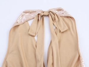 Detail of champagne sequin halter top featuring an elegant back tie-up ribbon bow