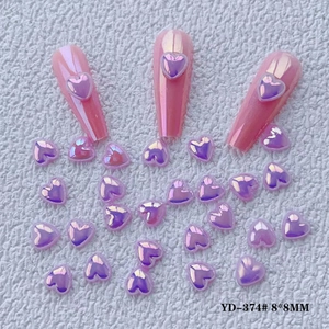 Detail of 8x8mm aurora heart nail charms with purple-pink shimmer and sample display
